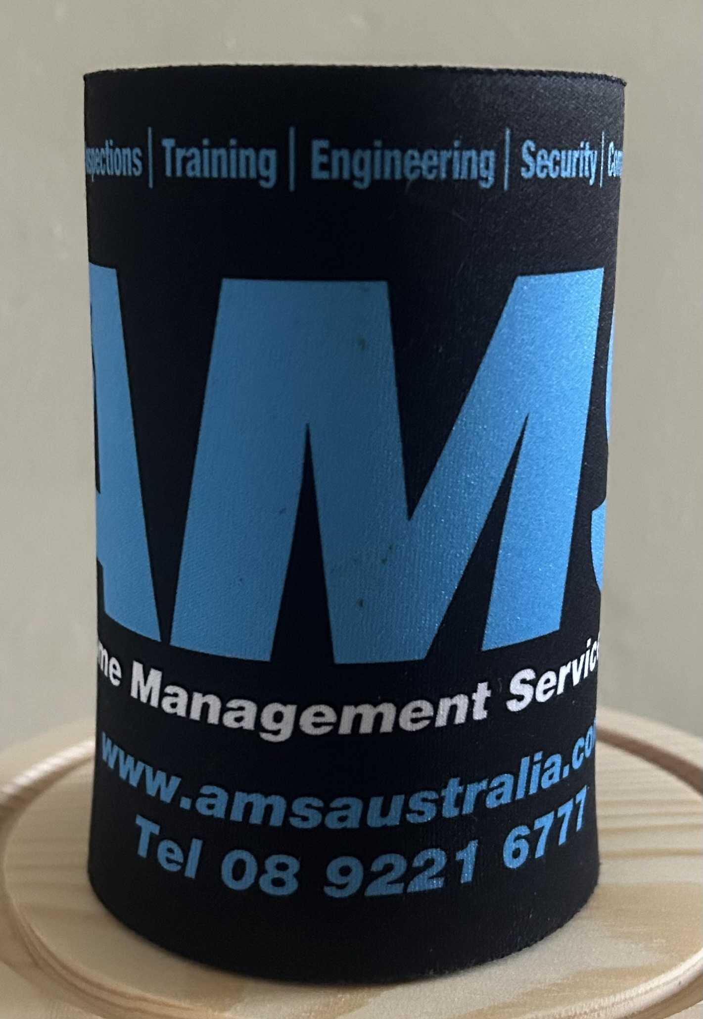 A Black Stubby Cooler by APJ Manufacturing.