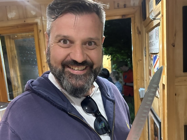 Mad looking man with a knife.